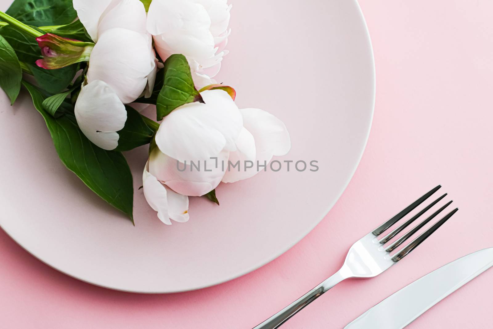 Dining plate and cutlery with peony flowers as wedding decor set on pink background, top tableware for event decoration and menu branding design