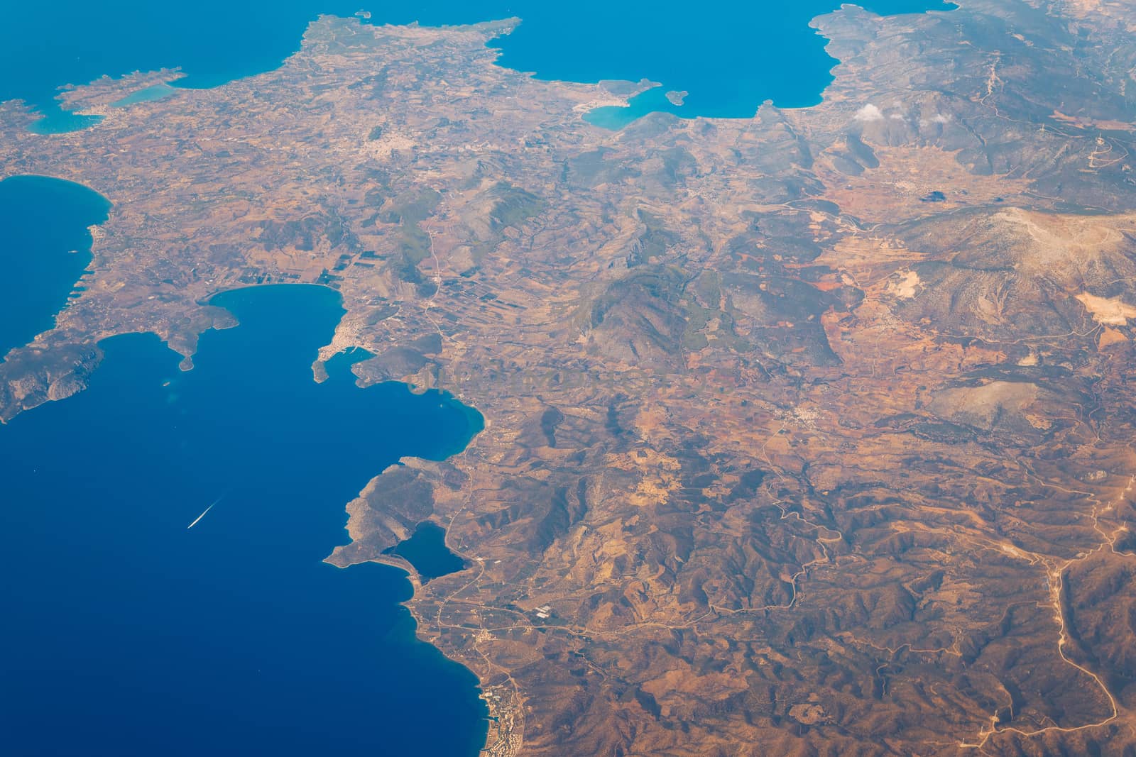 View On Adriatic From Plane. Traveling, Holiday, Vacation Concept. View from airplane on Earth surface. Landscape view of islands from the airplane. Greece Islands From Airplane