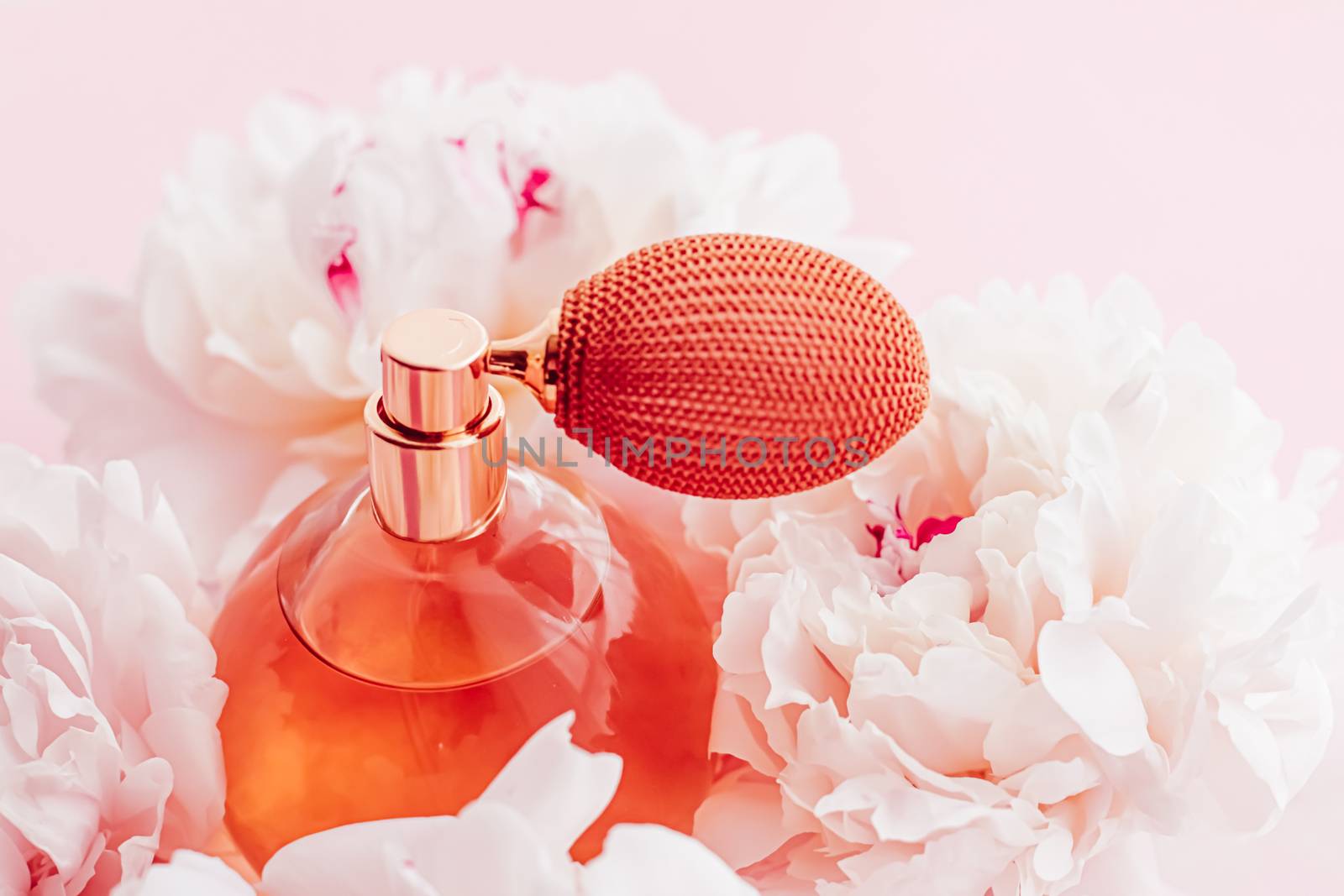 Vintage fragrance bottle as luxe perfume product on background of peony flowers, parfum ad and beauty branding design