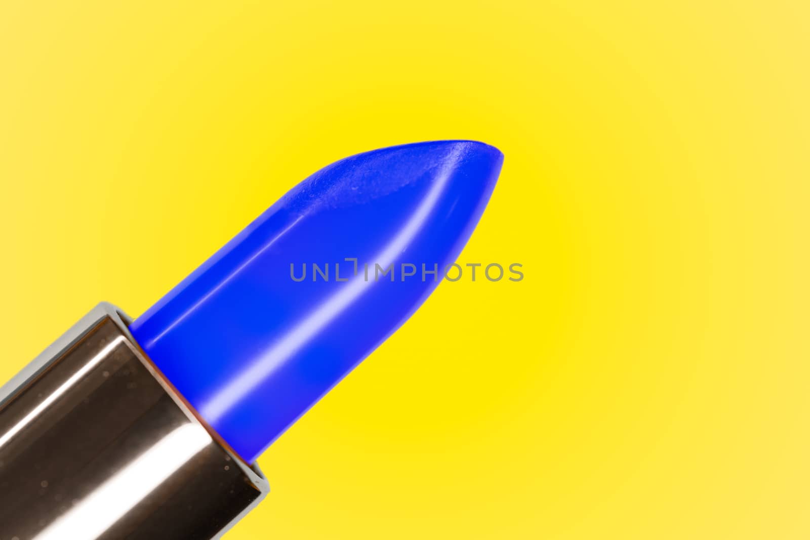 Beautiful bright classic blue lipstick and yellow complementary color on the background by tanaonte