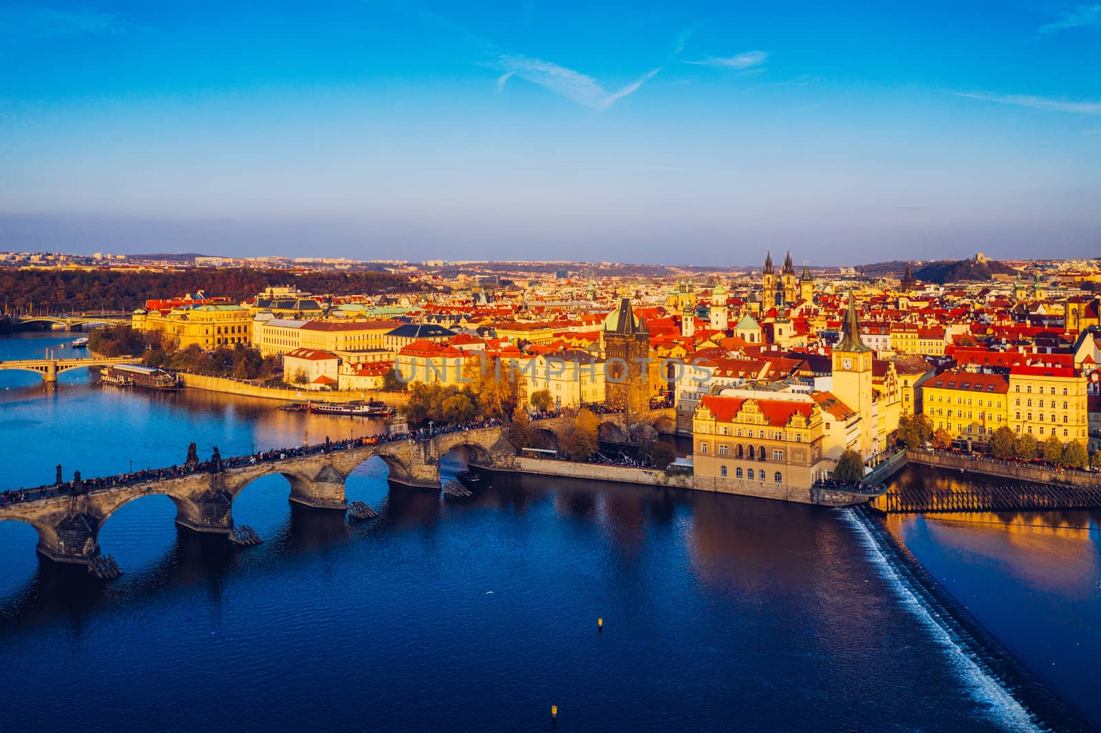 Aerial Prague panoramic drone view of the city of Prague at the Old Town Square, Czechia. Prague Old Town pier architecture and Charles Bridge over Vltava river in Prague at sunset, Czech Republic. 