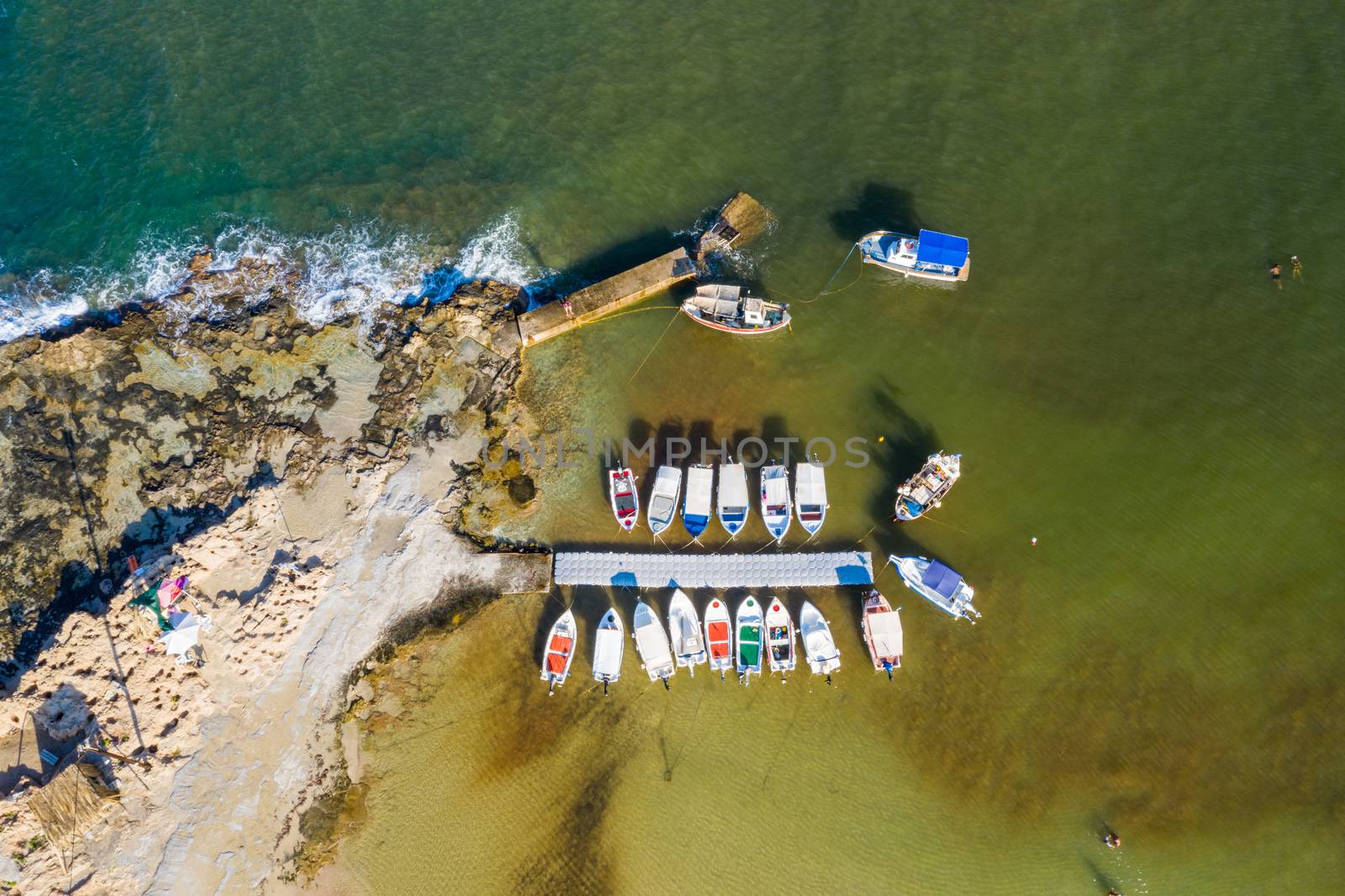 Aerial drone top view of turquoise organised beach forming a small heart shaped lagoon and mountainous seascape of Stavros, Chania, Crete island, Greece. Picturesque Stavros beach at Crete, Greece.