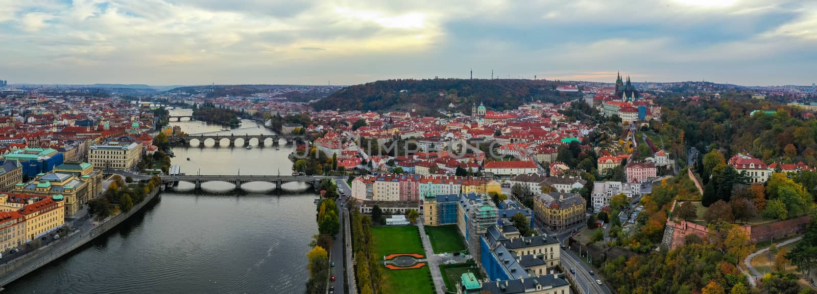 Aerial Prague panoramic drone view of the city of Prague at the Old Town Square, Czechia. Prague Old Town pier architecture and Charles Bridge over Vltava river in Prague at sunset, Czech Republic. 