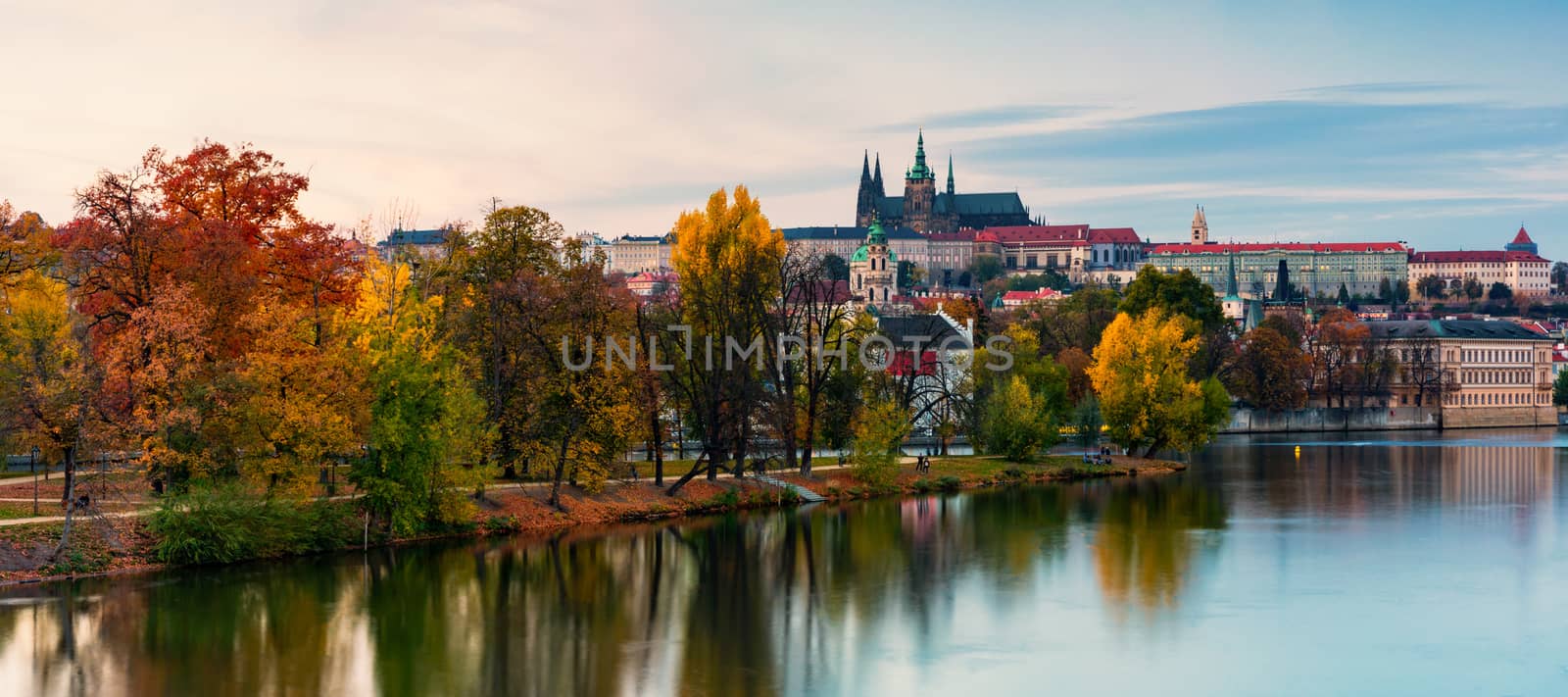 Prague autumn landscape. Prague autumn landscape view to Saint Vitus cathedral. Prague. Prague panorama. Prague, Czech Republic. Scenic autumn aerial view of the Old Town with red foliage. Czechia.