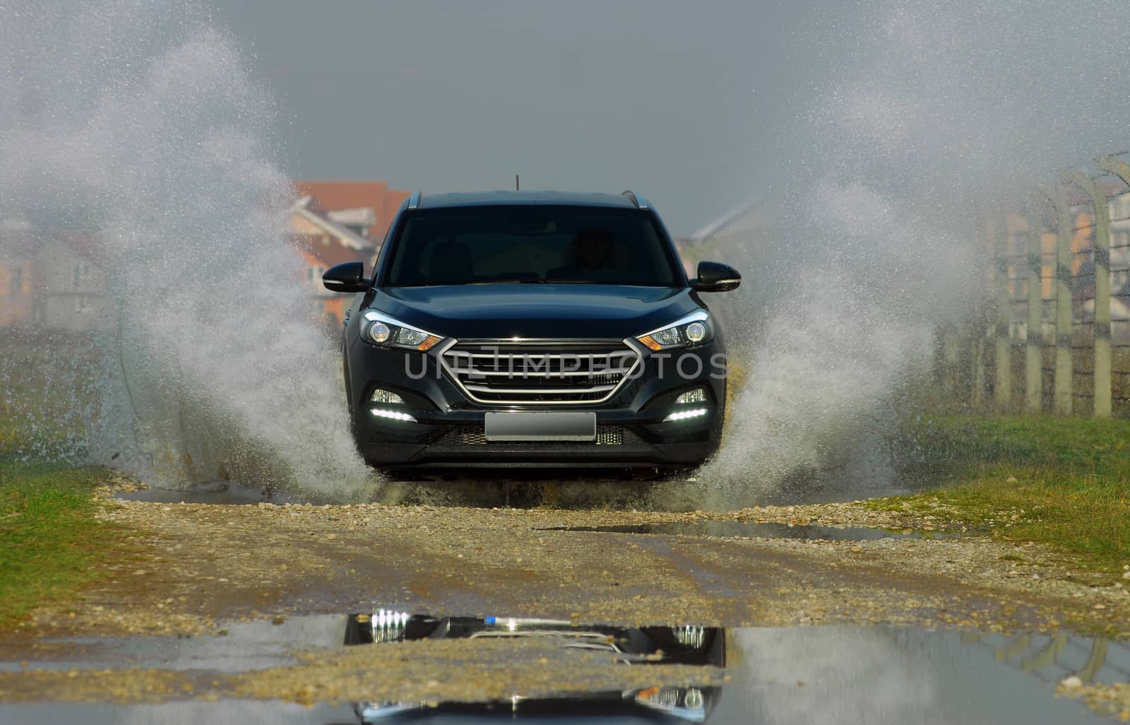 suv drives through flooded road