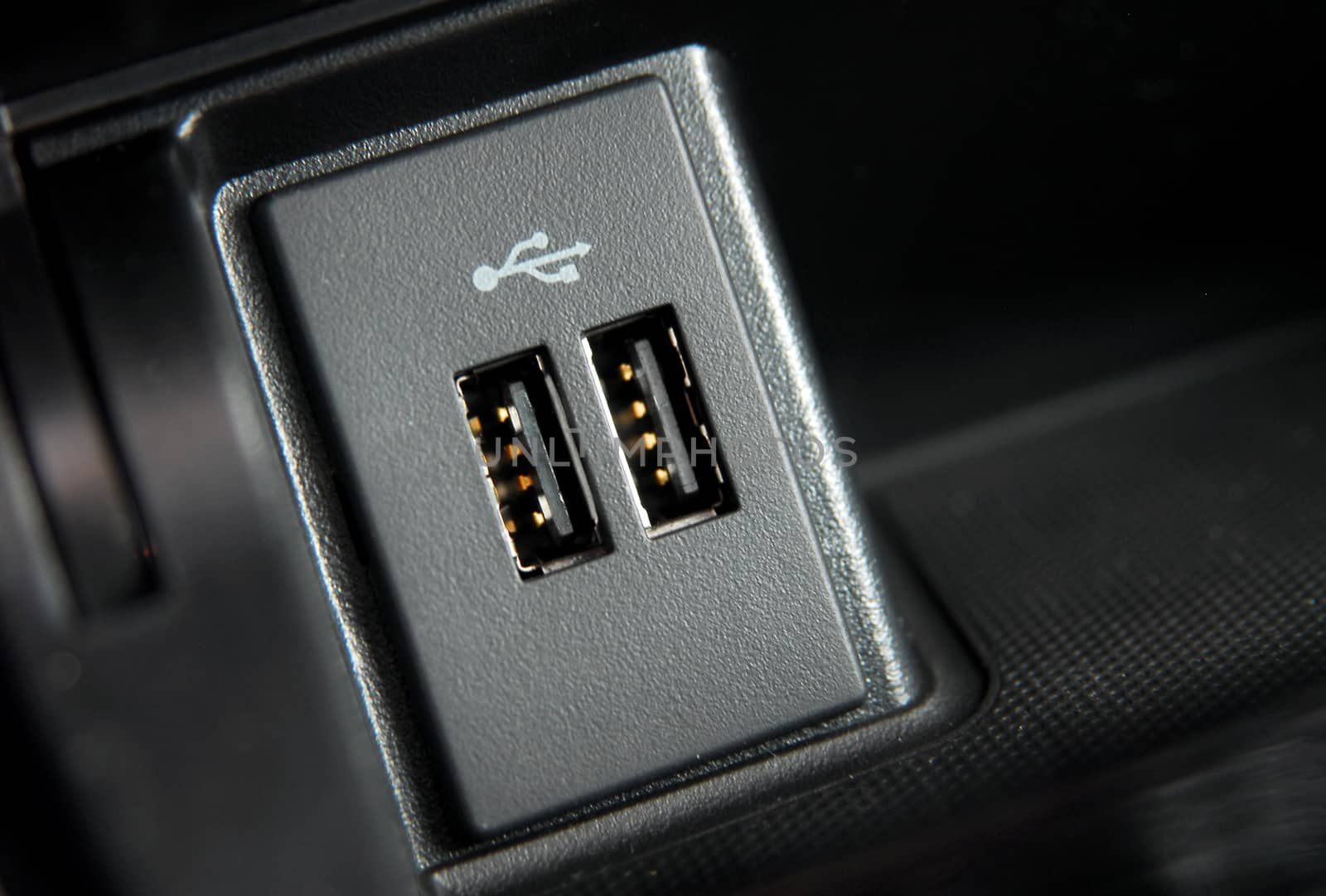 two usb ports on the dashboard of a modern passenger car