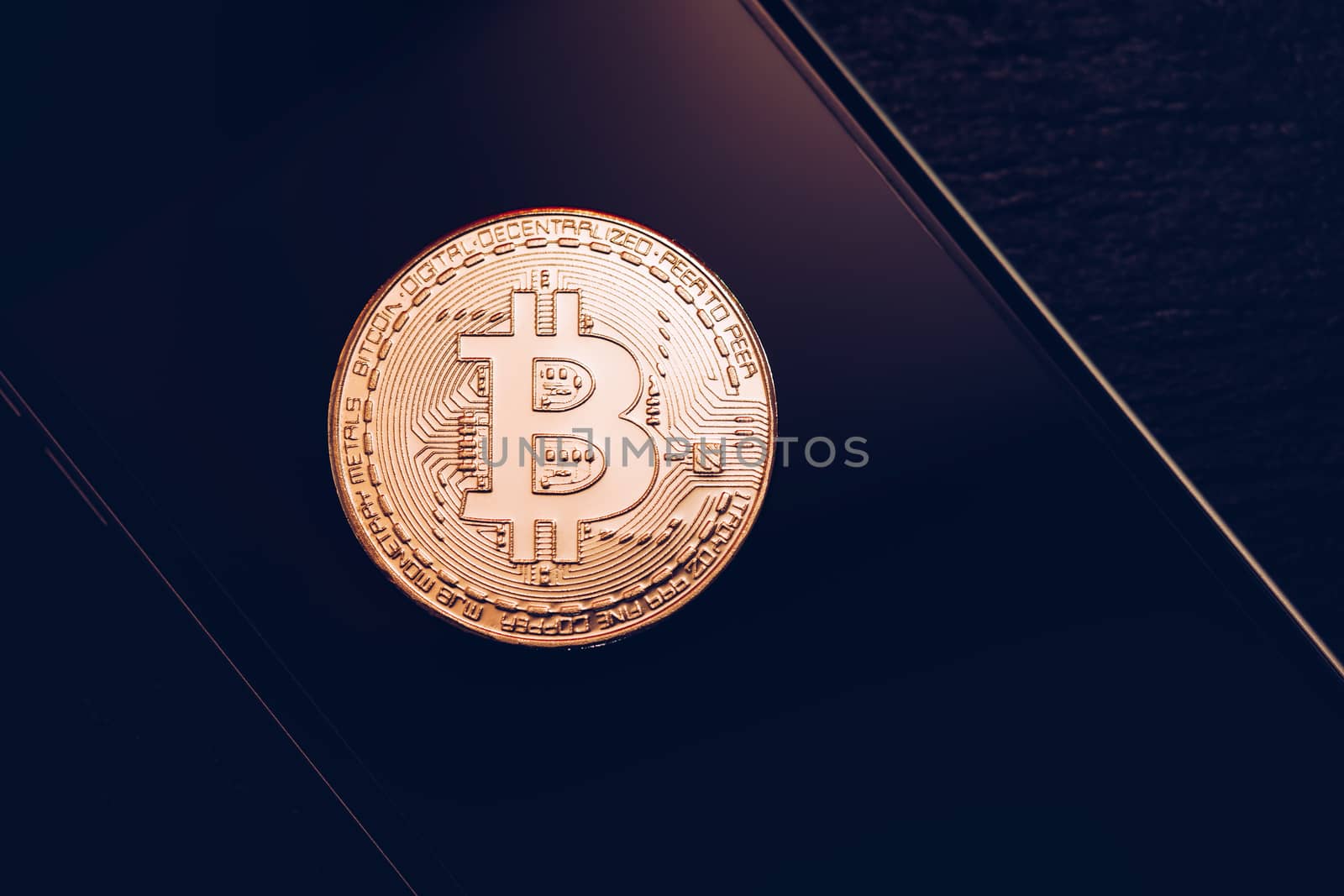 Bitcoin symbol over mobile screen, minimalist approach. Bitcoin on stock market. New digital money. Golden Bitcoin over smartphone display.