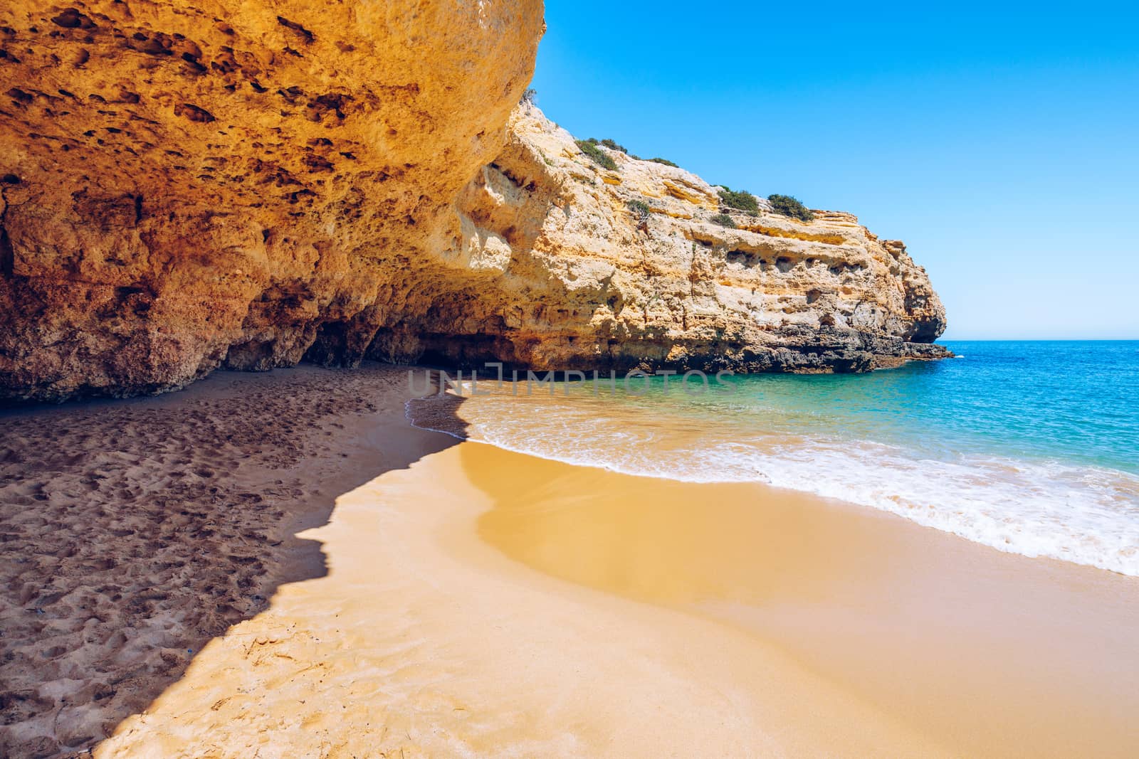 Soft wave of blue ocean on sandy tropical beach. Background of tropical paradise beach with golden sand, travel tourism panorama background concept. Sand and sea waves background.