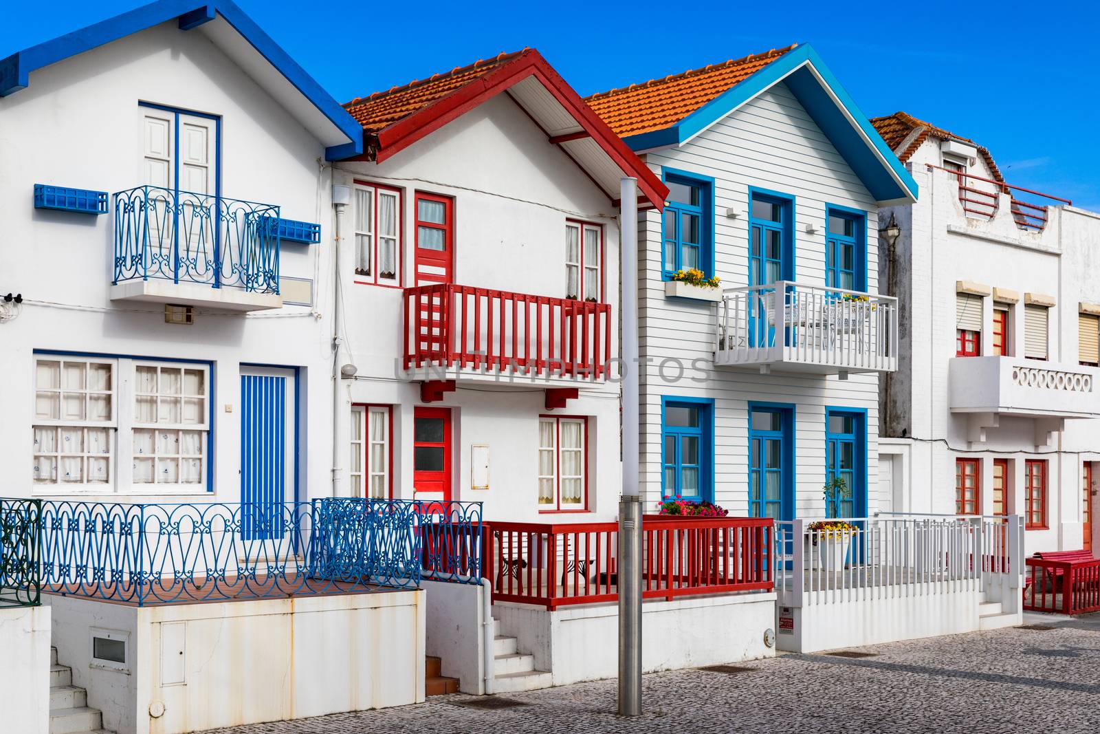 Street with colorful houses in Costa Nova, Aveiro, Portugal. Street with striped houses, Costa Nova, Aveiro, Portugal. Facades of colorful houses in Costa Nova, Aveiro, Portugal.