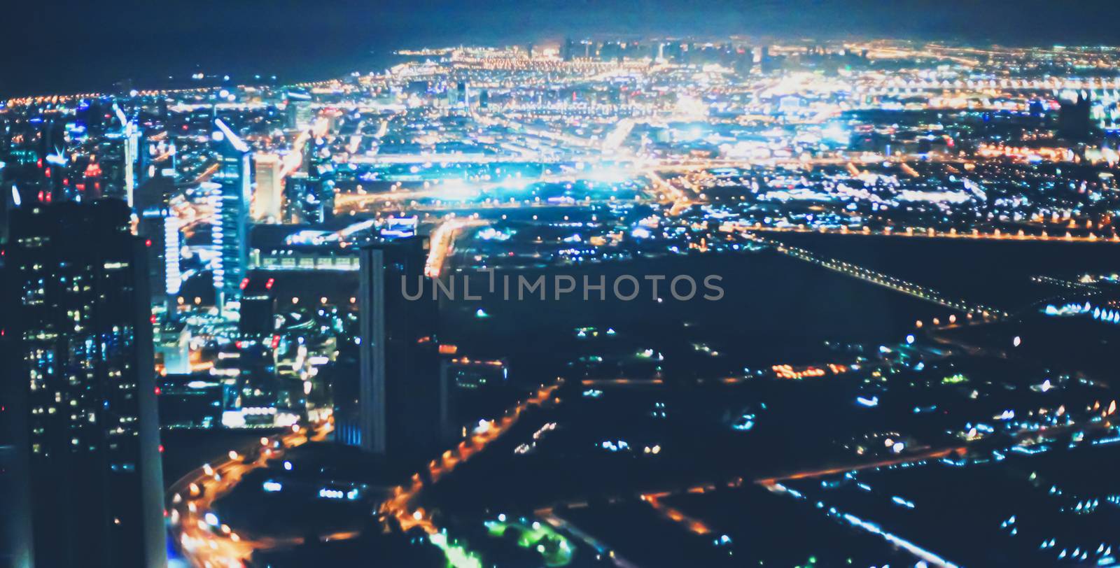 Aerial night view of Dubai in United Arab Emirates, metropolitan cityscape scenery