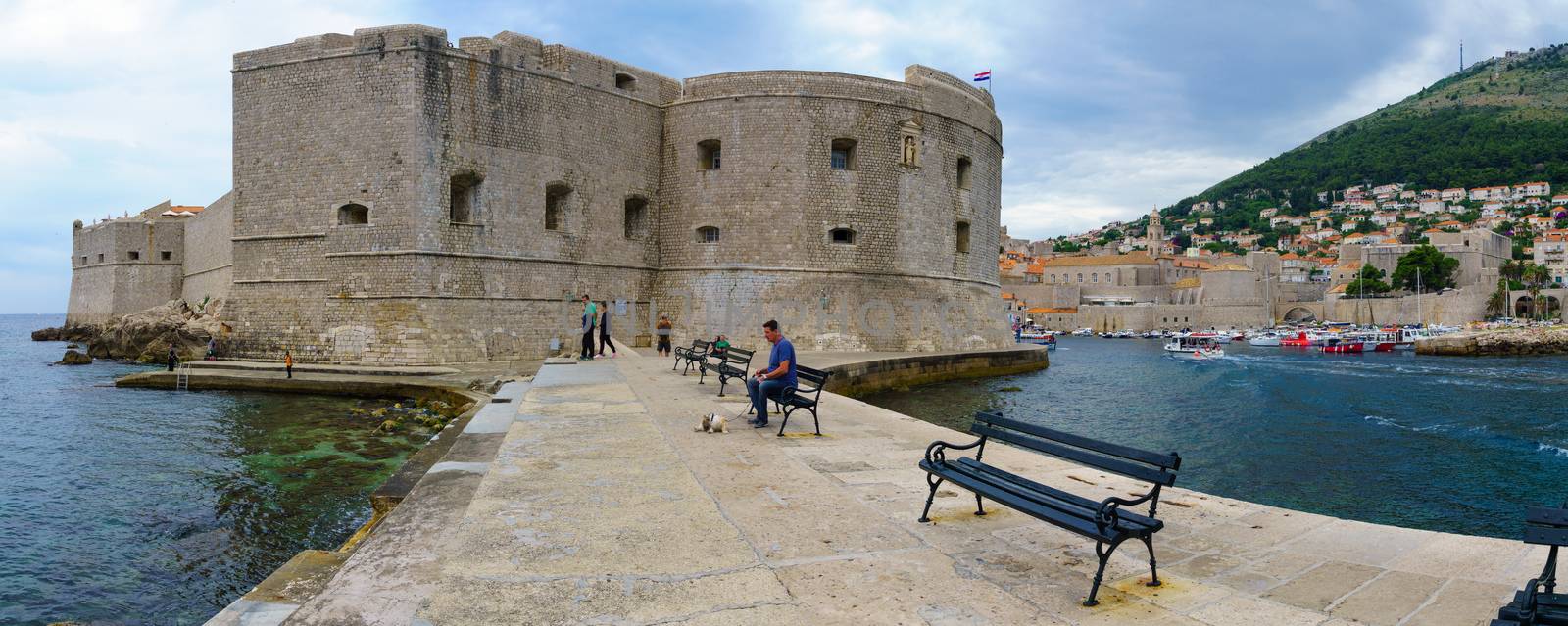 DUBROVNIK, CROATIA - JUNE 28, 2015: Panoramic view of the Porporela promenade and the port, with locals and tourists, in Dubrovnik, Croatia