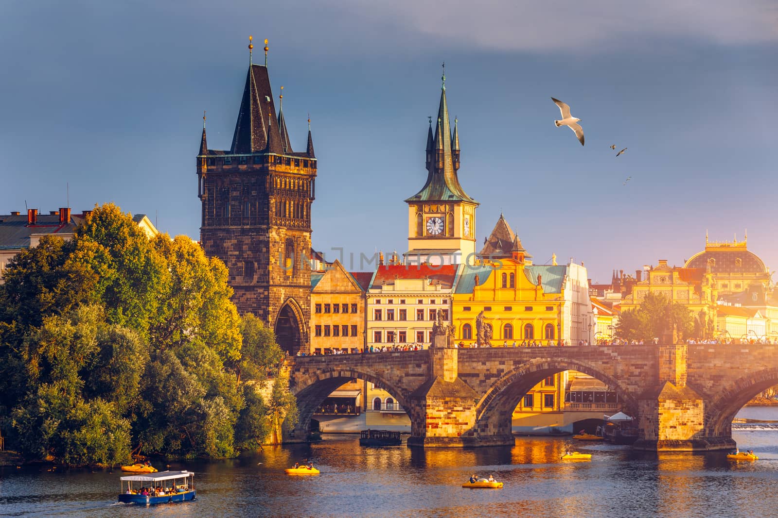 Autumn view to Charles bridge on Vltava river in Prague, Czech Republic. Autumn view to Charles Bridge, Prague old town and Vltava river. Czechia. Scenic autumn view of the Old Town with red foliage.