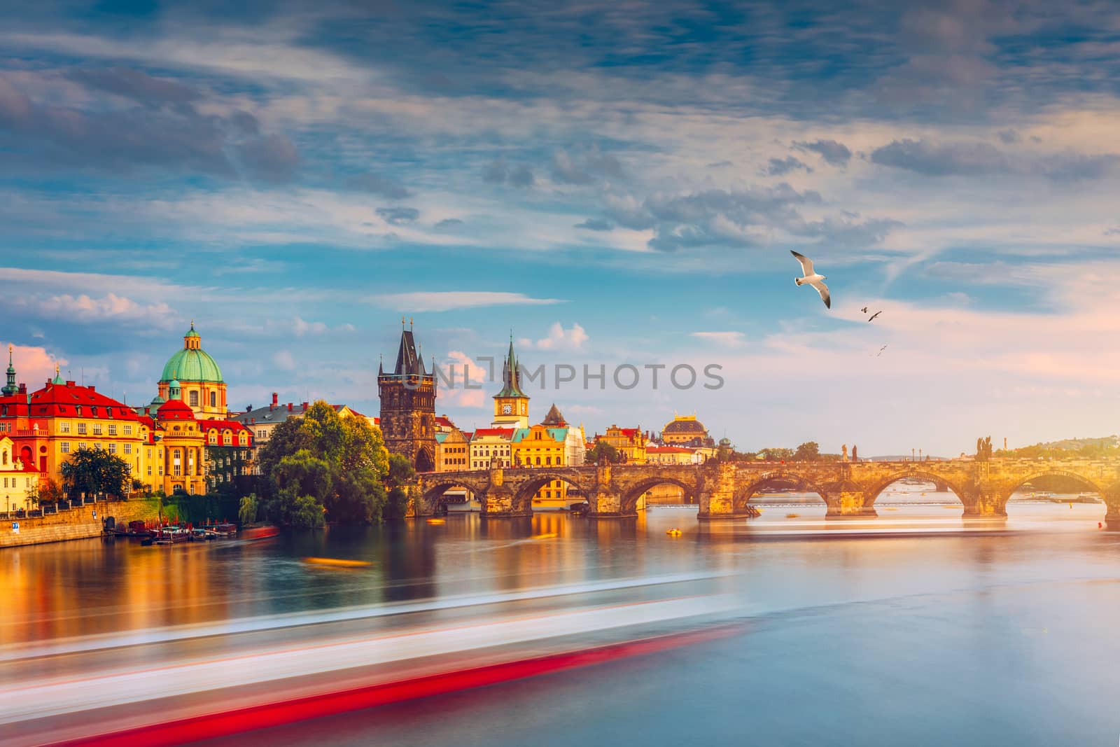 Prague Castle, Charles Bridge and boats on the Vltava river. View of Hradcany Prague Castle, Charles Bridge and a boats on the Vltava river in the capital of the Czechia. Boat cruise on Vltava river.