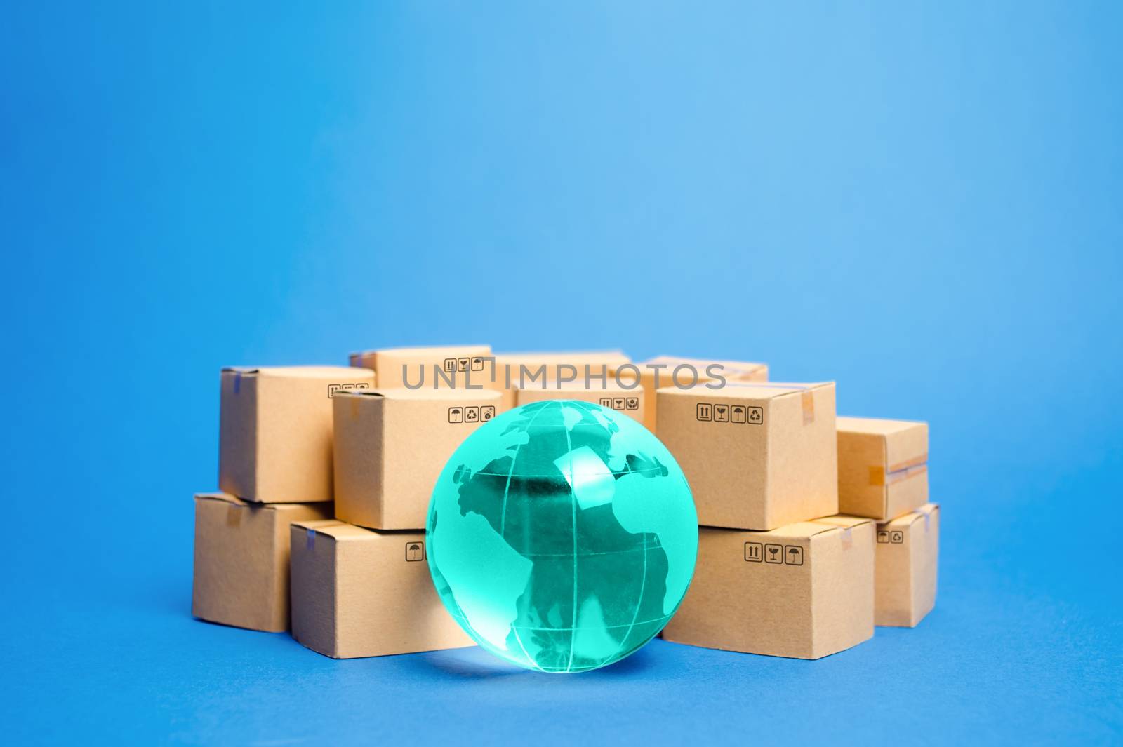 Earth globe is surrounded by boxes. Global business and international transportation of goods products. Shipping freight, world trade and economics. Distribution, import export. Commodity turnover
