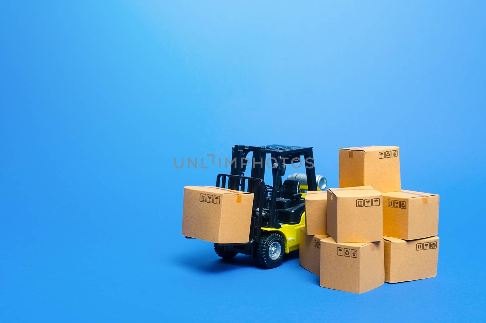 Forklift truck with cardboard boxes. Transportation logistics infrastructure, import and export goods and products delivery. Production, transport, cargo storage. Freight shipping. retail