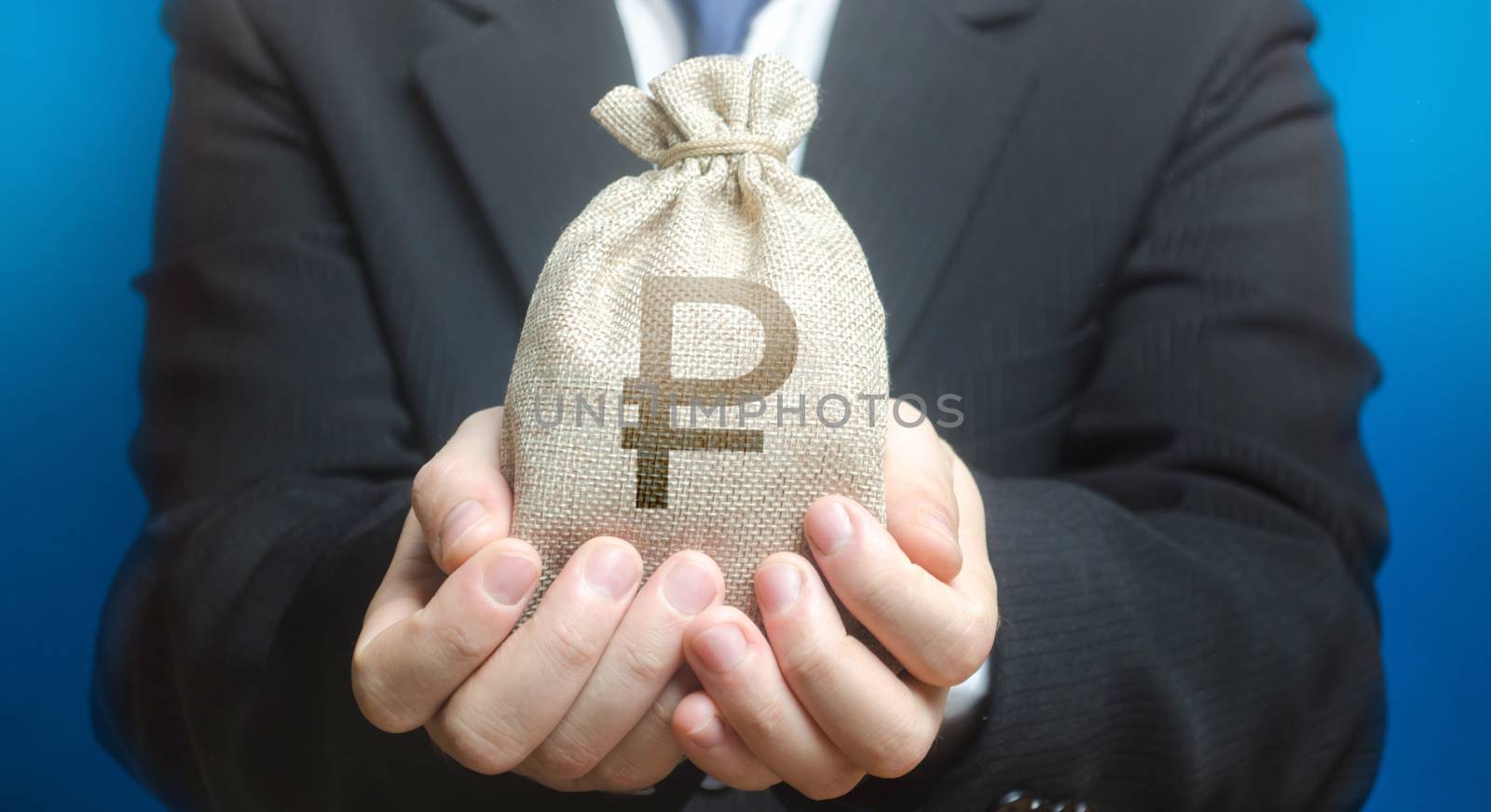 A man holds out a russian ruble money bag. Budget management, tax collection. Provision cash financial loan credit. Trade, economics. Granting financing business project or education. Bank deposit.