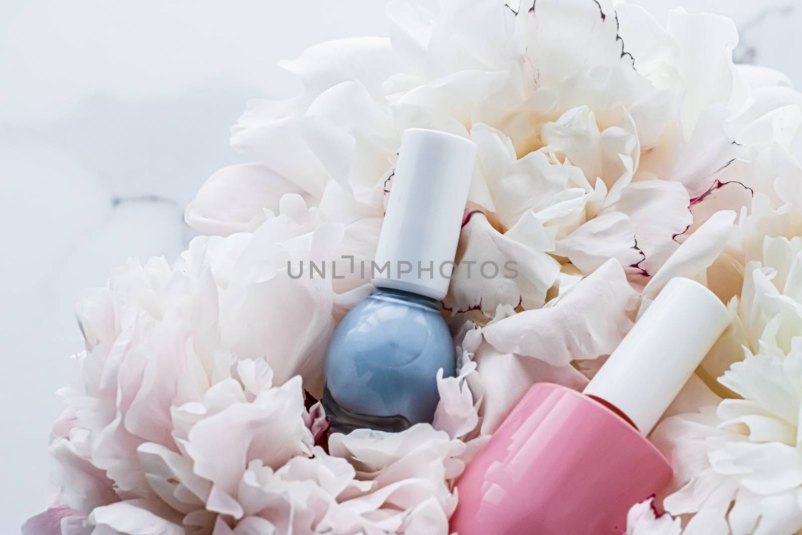 Nail polish bottles on floral background, french manicure and cosmetic branding by Anneleven