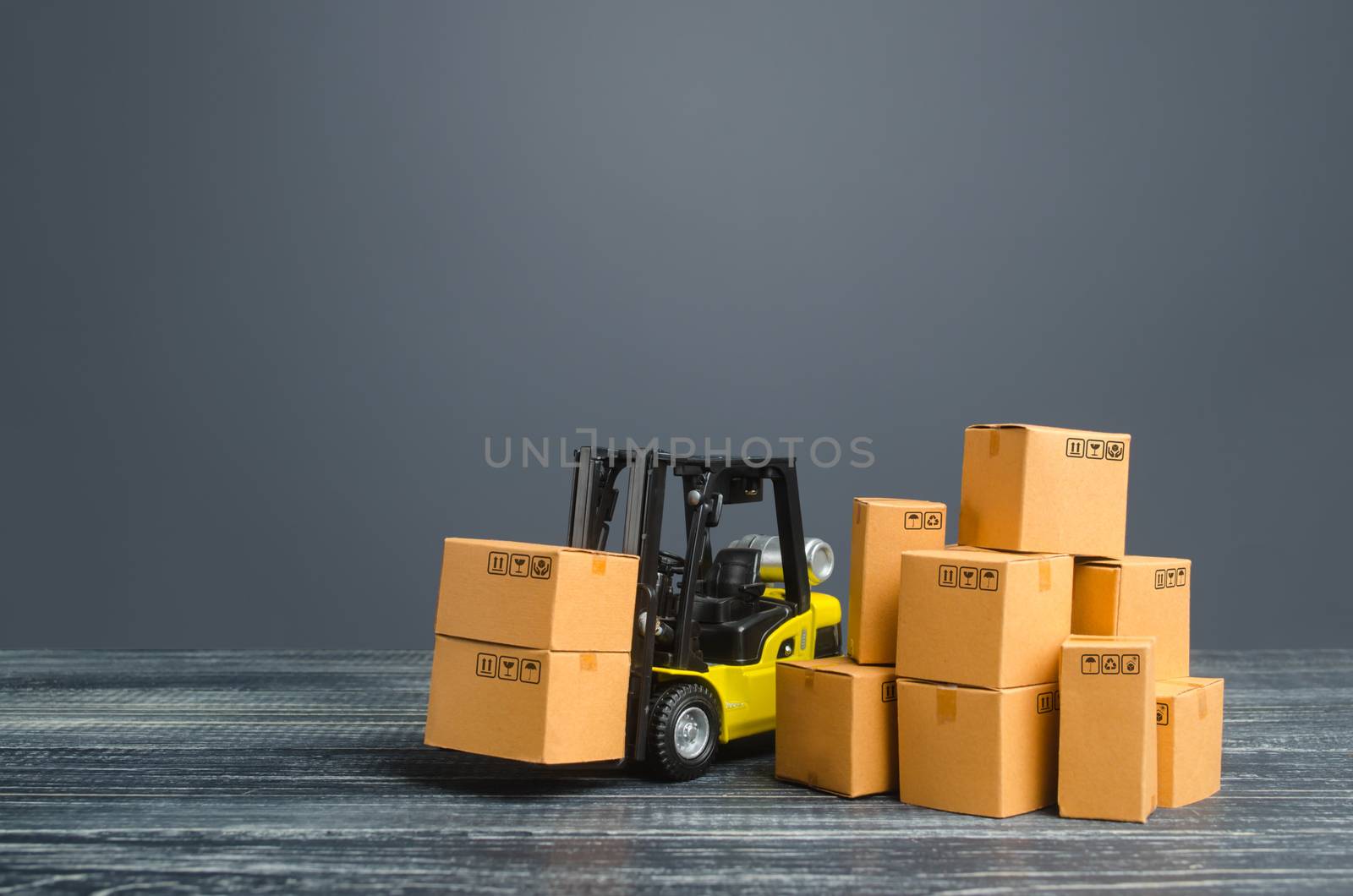 Yellow Forklift truck and cardboard boxes. Production, transport, cargo storage. Freight shipping. retail. Transportation logistics infrastructure, import and export goods and products delivery