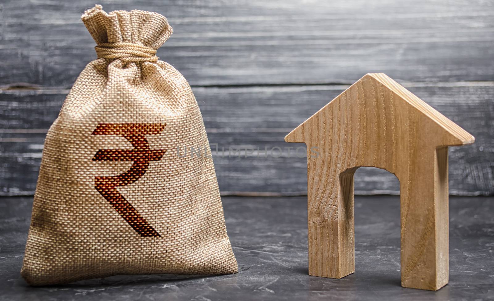 Indian rupee INR symbol money bag and house. Real estate purchase and investment. Affordable loan, mortgage. Taxes, rental income. rent or buy. Home budget. Maintenance of a residential building.