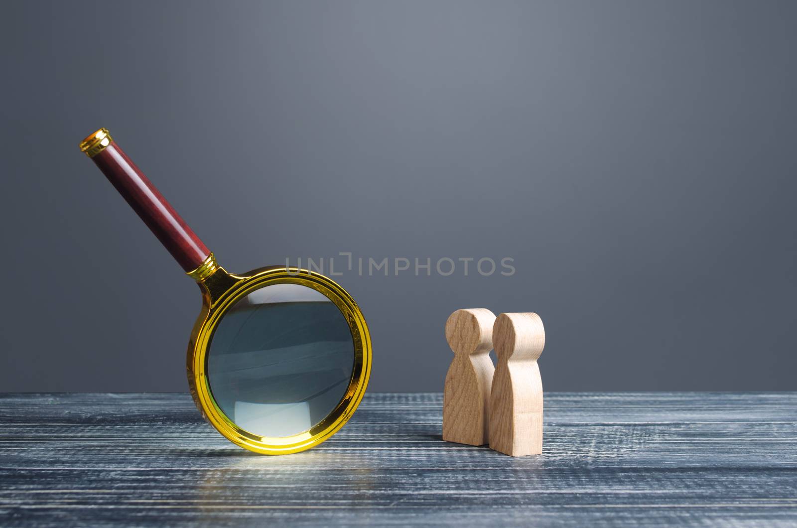 People look at a huge magnifying glass. Search and analysis, analytics and study. Pay attention to details and problems. Find something. Journalistic investigations and research. Emphasize attention