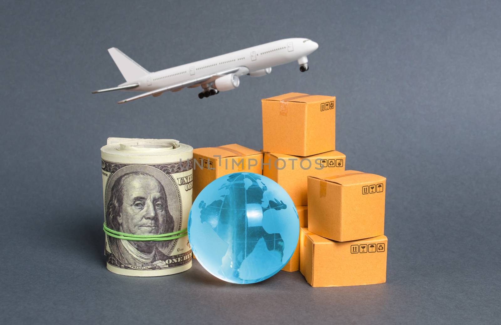 A stack of boxes, airplane a bundle of dollars and a blue planet earth globe. World trade and commodity exchange. commerce traffic trading balance. Import, export, transit of products.