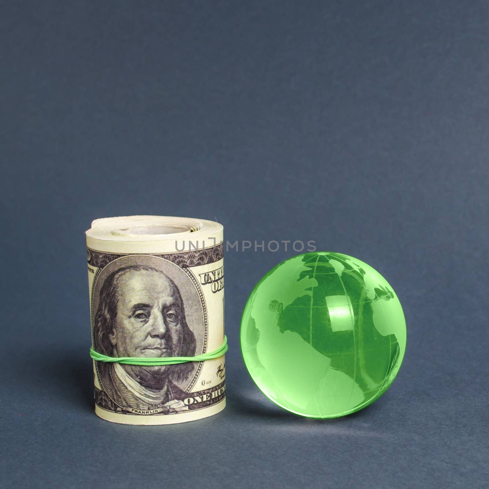 Roll of dollars and green planet earth globe. International money transfers, attraction of investments. Global financial system. World trade and economic relations ties. Business industry. minimalism by iLixe48