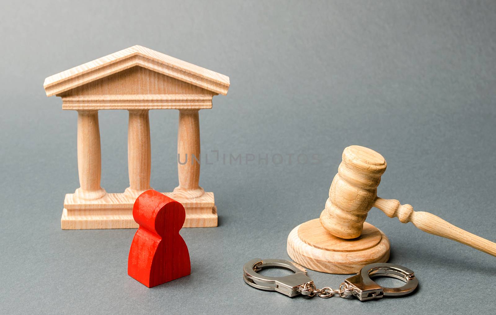 Red figurine of a man at the trial. Protection of the defendant in the criminal case. Protection strategy. verdict on the case. Investigation of the crime. judicial system, execution of sentences.