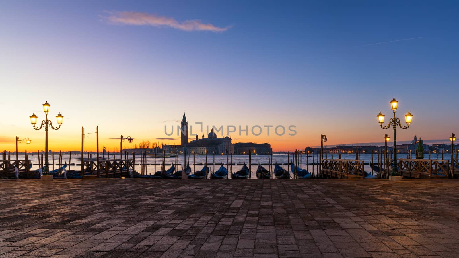 Scenic view of San Giorgio Maggiore, gondolas and lamp at colorful sunrise, Venice, Italy. Sunset in Venice. Gondolas at Saint Mark's Square and church of San Giorgio Maggiore on background, Italy, Europe