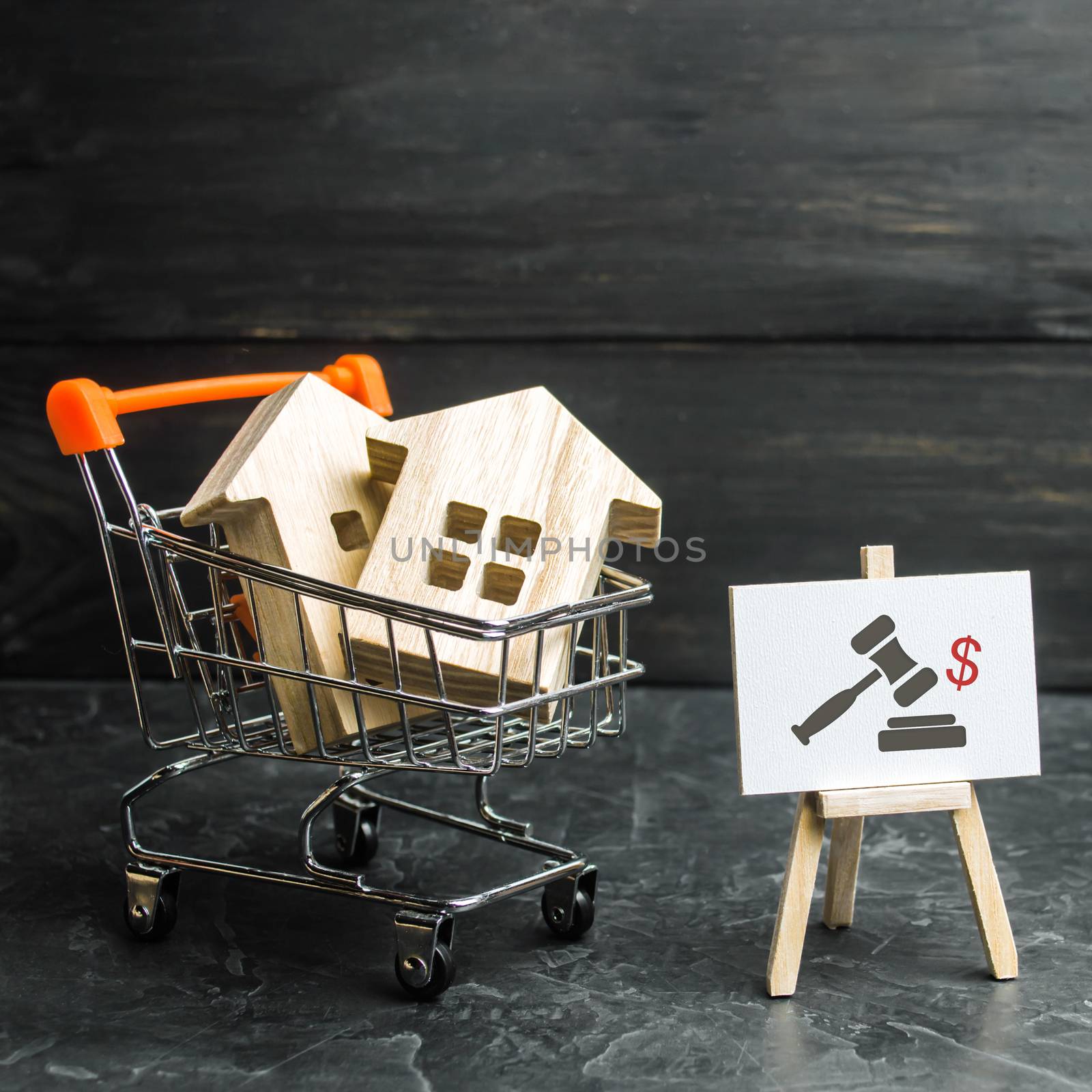 Wooden houses in a supermarket cart. uction for the purchase of housing and buildings. The growth of the city and its population. Investments. concept of rising prices for housing or rent