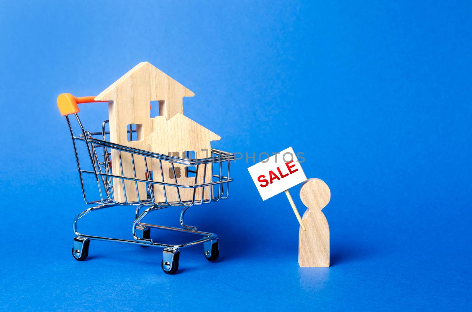 A person with a sign for sale stands near the house. concept of selling a home, buying from the owner. Buying and selling real estate, Realtor Services. Search for housing