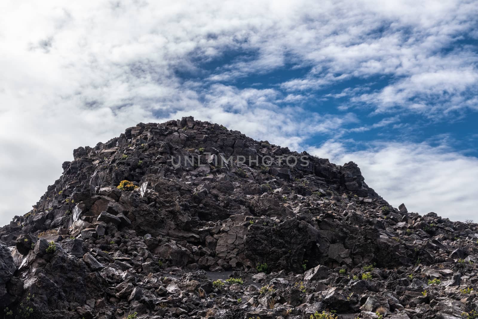 Mountain of lava rocks at edge of crater of Haleakala Volcano, M by Claudine