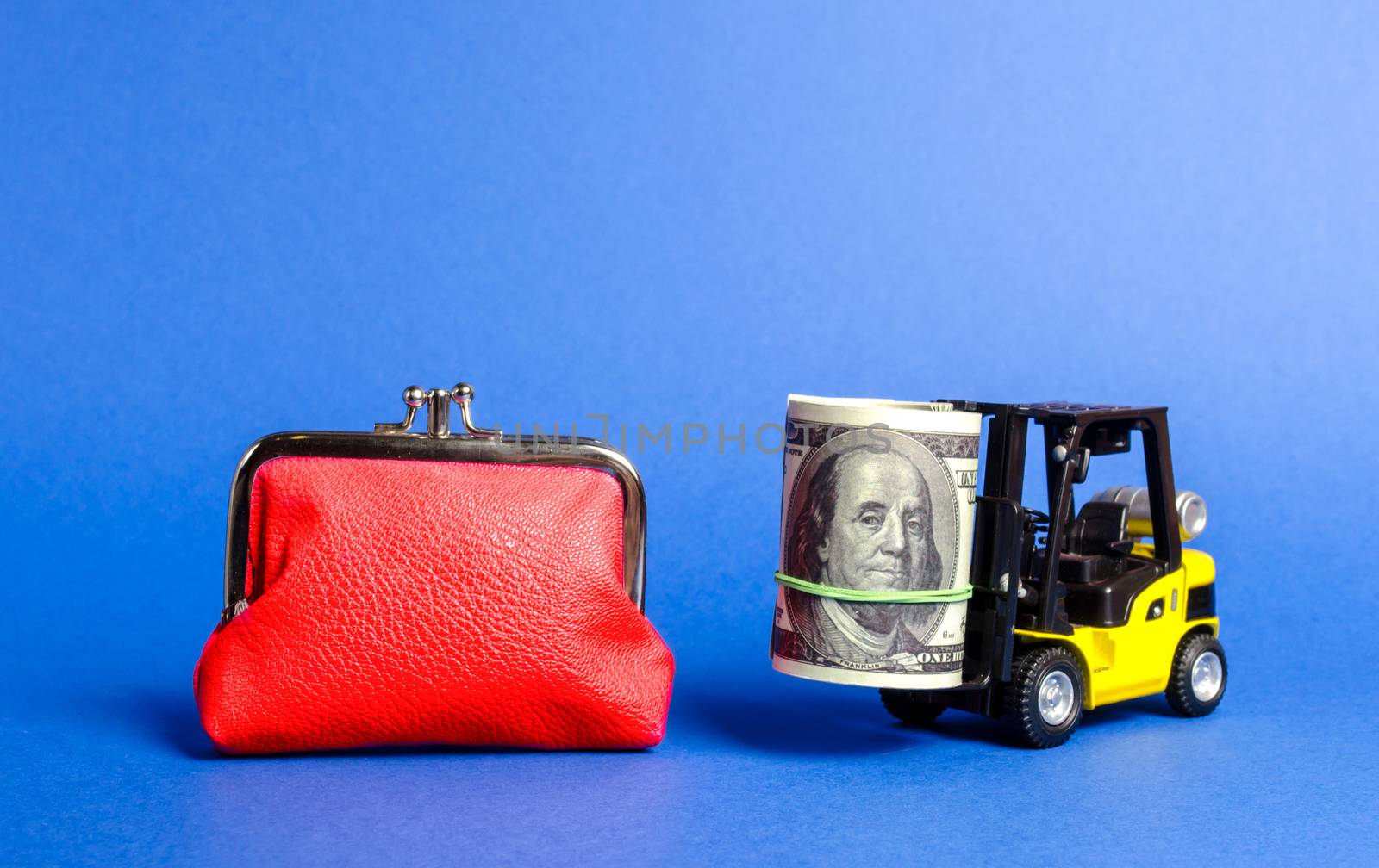 Forklift truck carries a bundle of dollars near a big red wallet. Loan portfolio and investment groups. Savings and deposits on favorable terms. Attracting direct investment in business and production by iLixe48