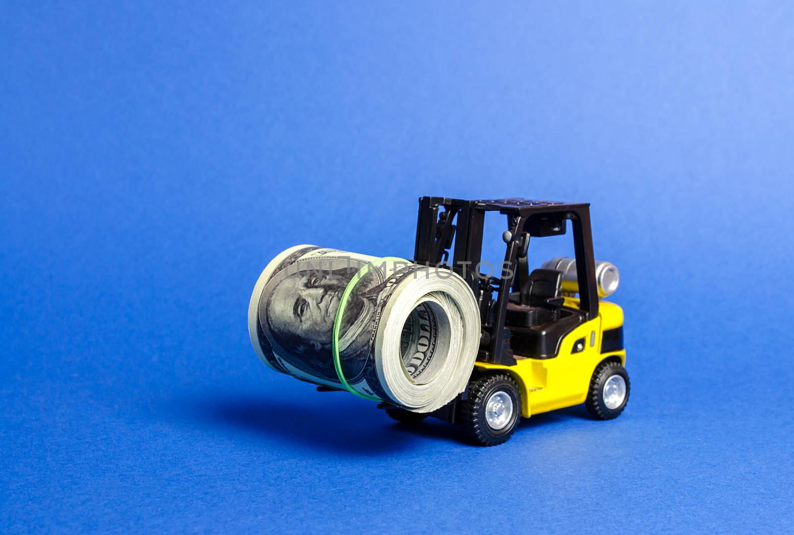 Forklift truck carries a bundle of dollars. Export of capital, offshore economic zones. Attracting direct investment in business and production, improving economic performance. capitalism.