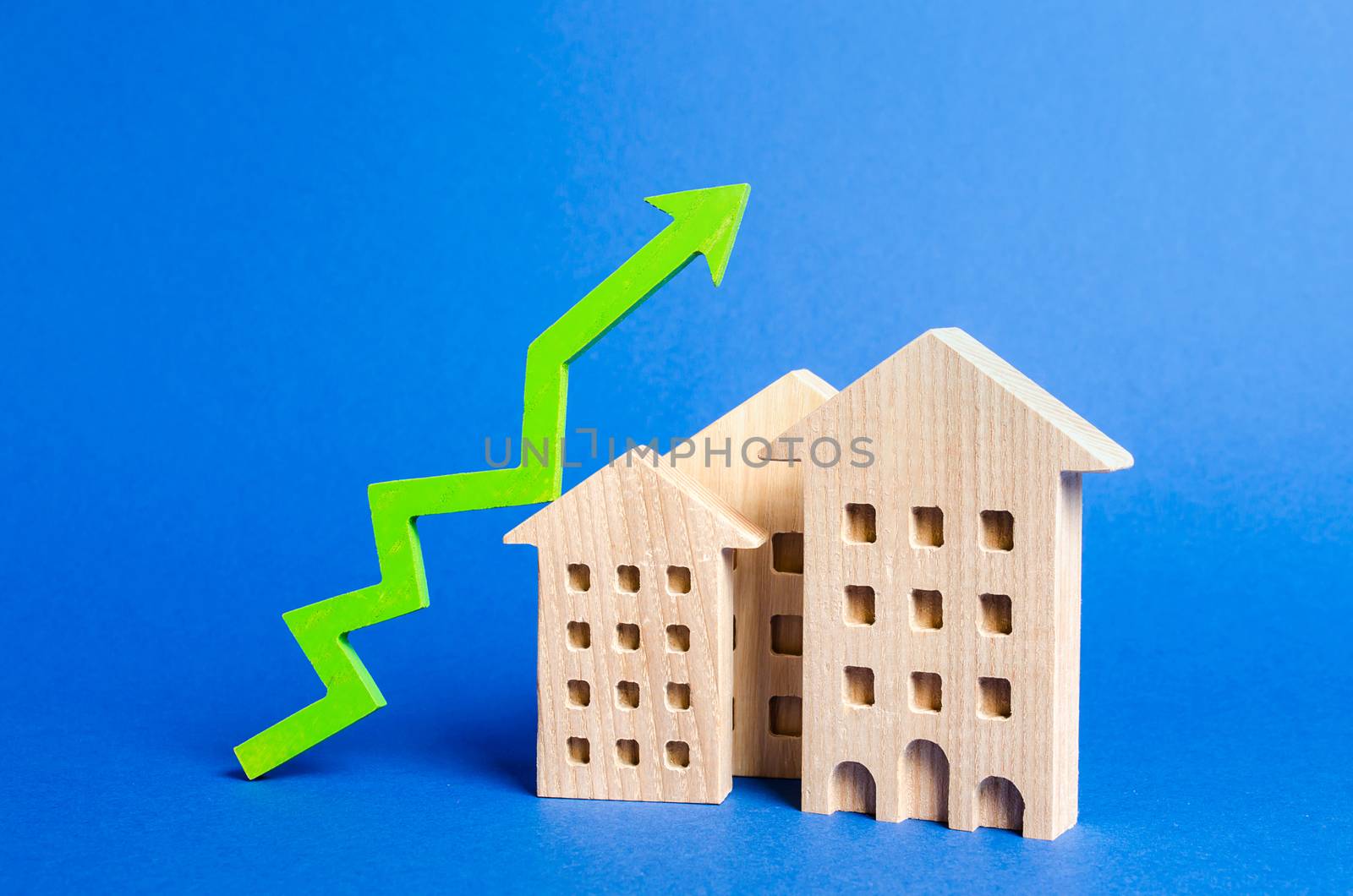 figures of residential buildings and green arrow up. Rising value and price. Apartments for sale. Growth in demand and liquidity for real estate, increase in rates for the maintenance of buildings. by iLixe48