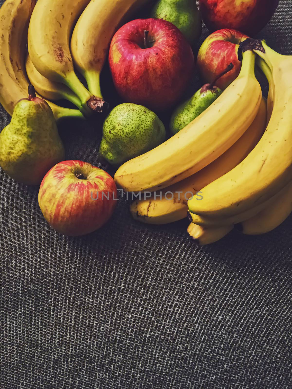 Organic apples, pears and bananas on rustic linen background by Anneleven