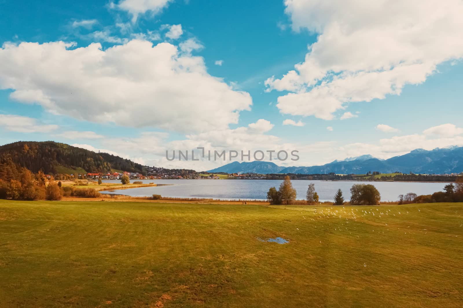 Beautiful nature of European Alps, landscape view of alpine mountains, lake and village in autumn season, travel and destination scenery