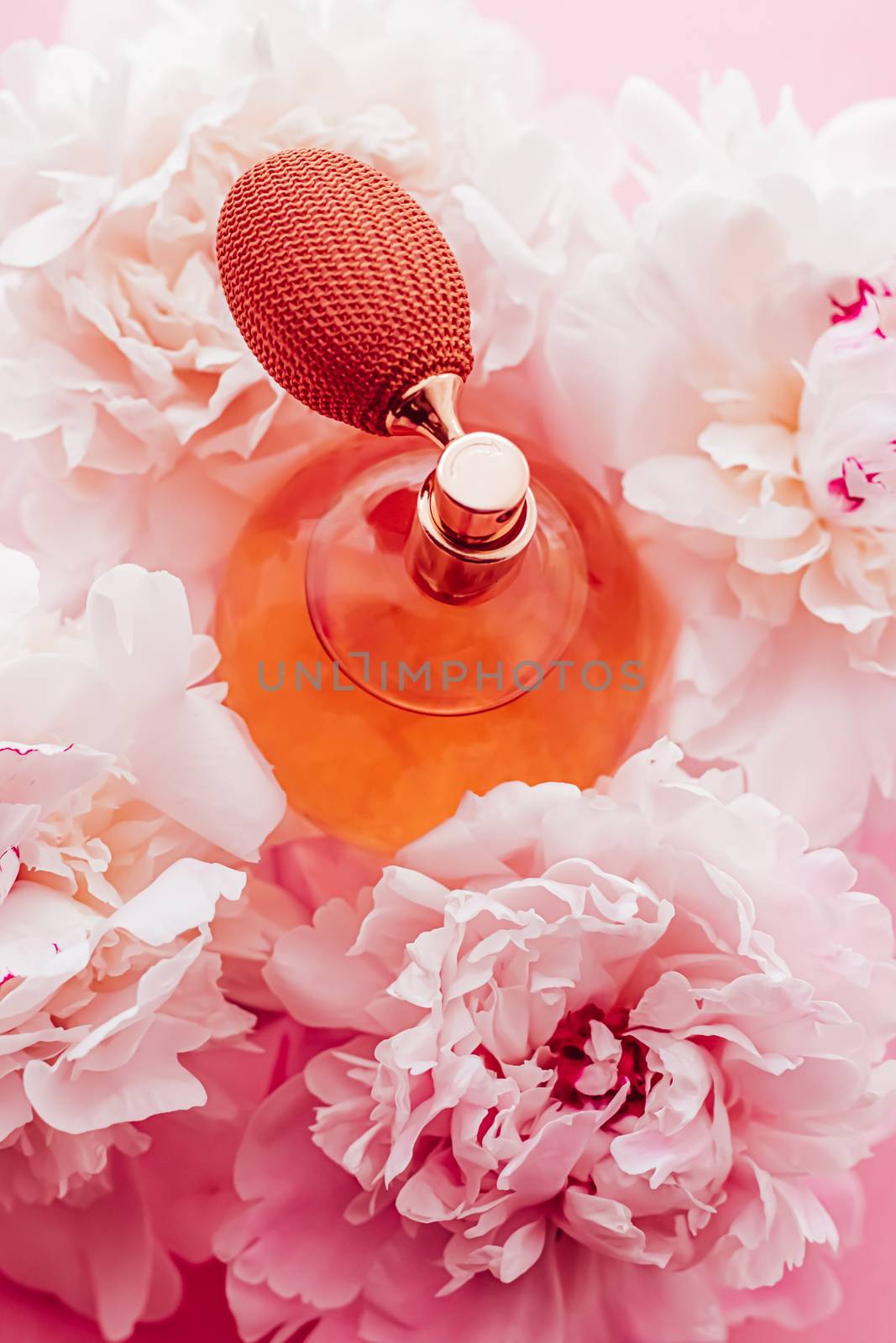 Vintage fragrance bottle as luxe perfume product on background of peony flowers, parfum ad and beauty branding by Anneleven