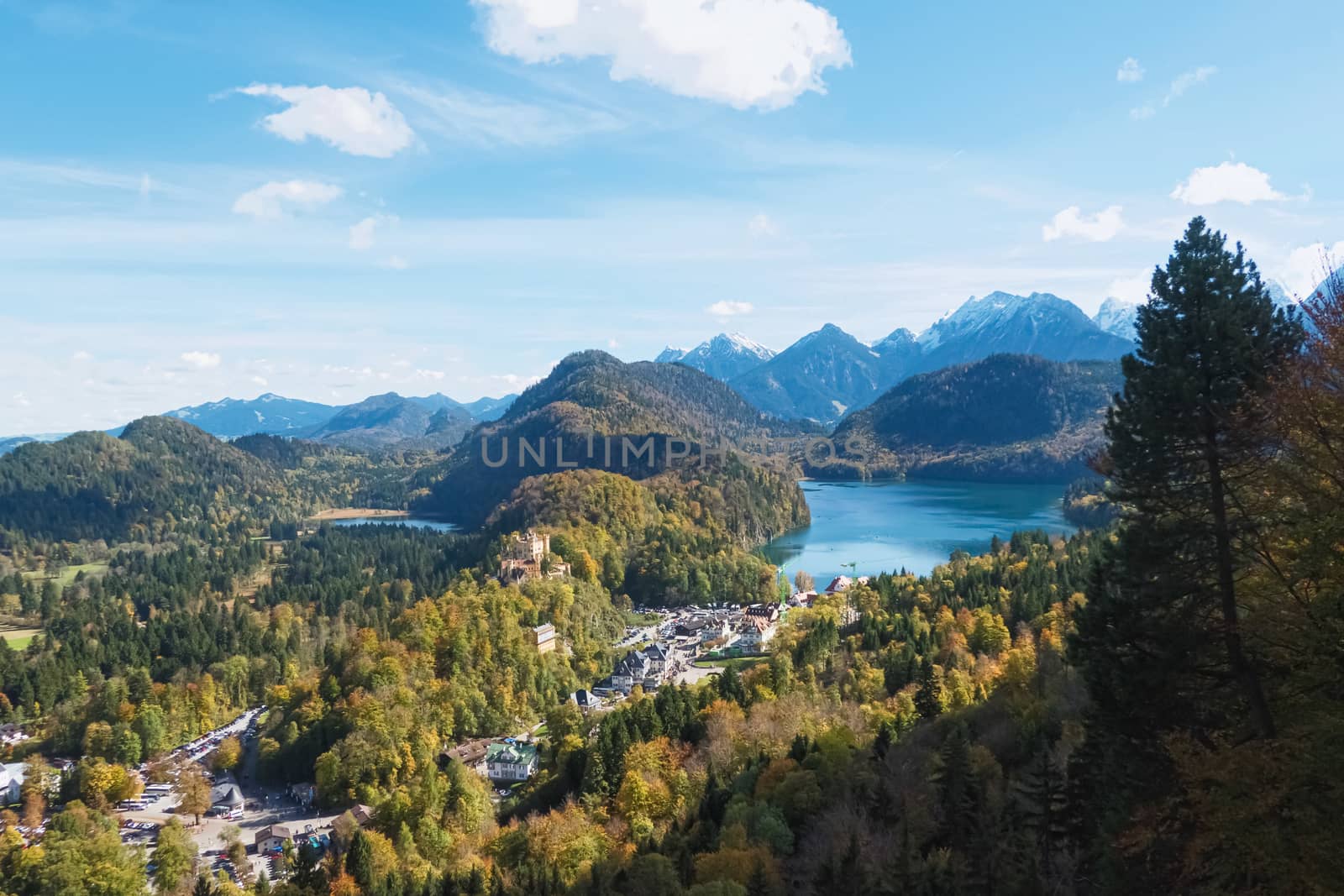 Beautiful nature of European Alps, landscape view of alpine mountains, lake and village on a sunny day, travel and destination scenery