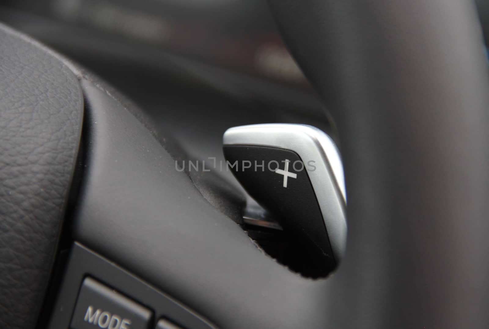manual gear changing stick on a car's steering wheel, car interior detail