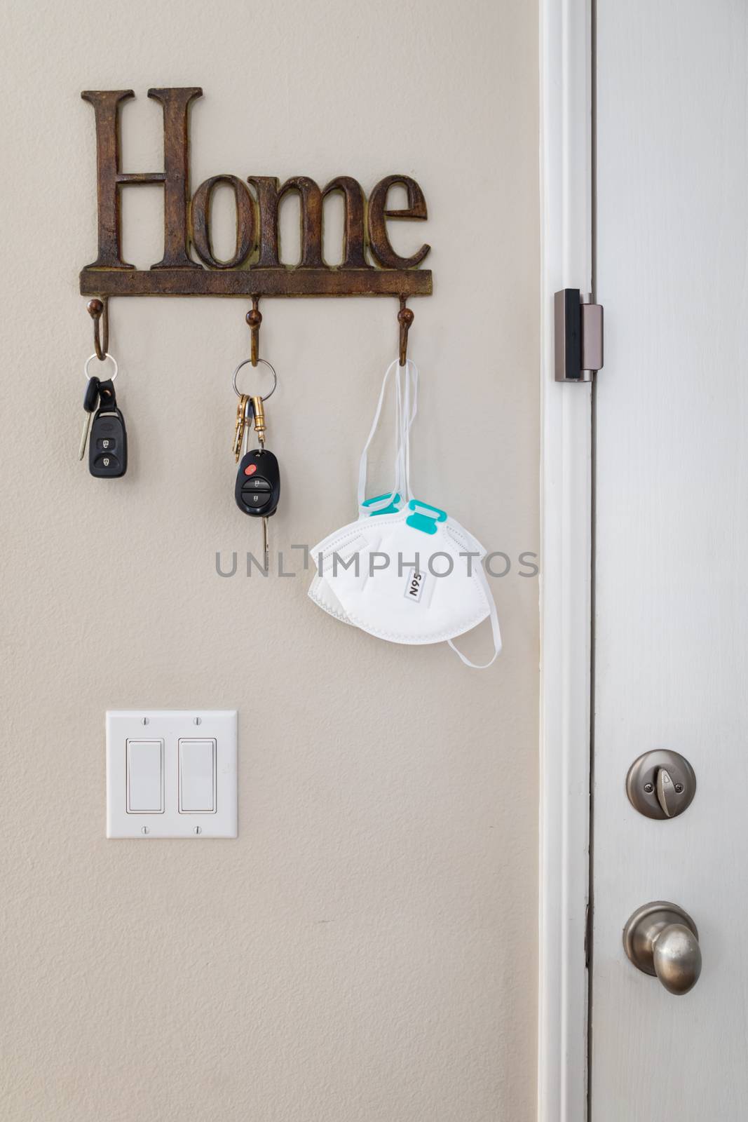 Home Key Hanger Rack Next to Door With Keys and Medical Face Mask During Coronavirus Pandemic.