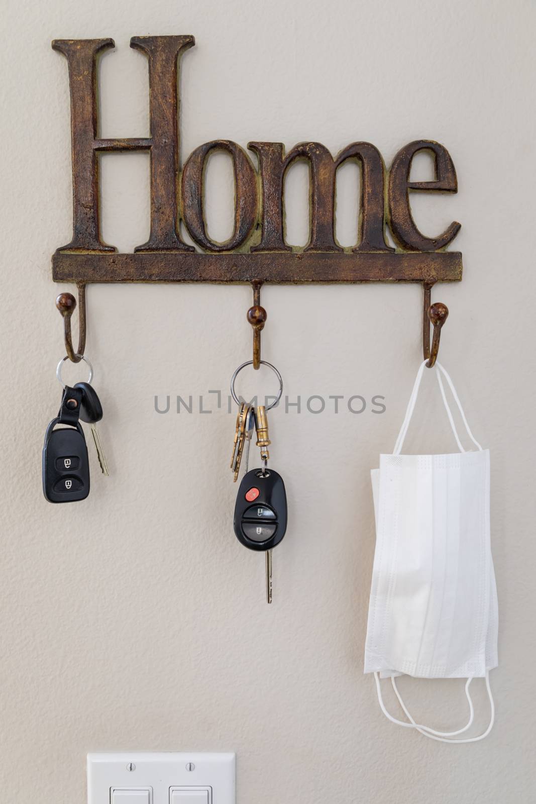 Home Key Hanger Rack Next to Door With Keys and Medical Face Mask During Coronavirus Pandemic.