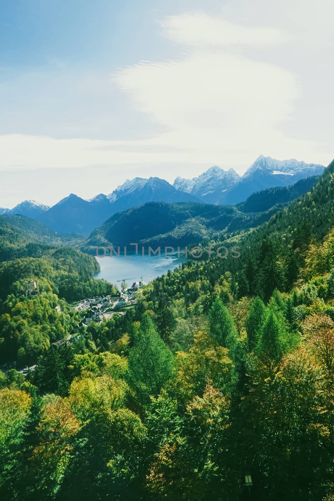 Beautiful nature of European Alps, landscape view of alpine mountains, lake and village in spring season, travel and destination scenery