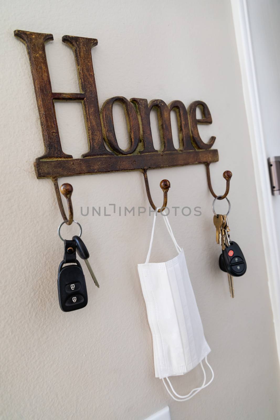 Home Key Hanger Rack Next to Door With Keys and Medical Face Mask During Coronavirus Pandemic.