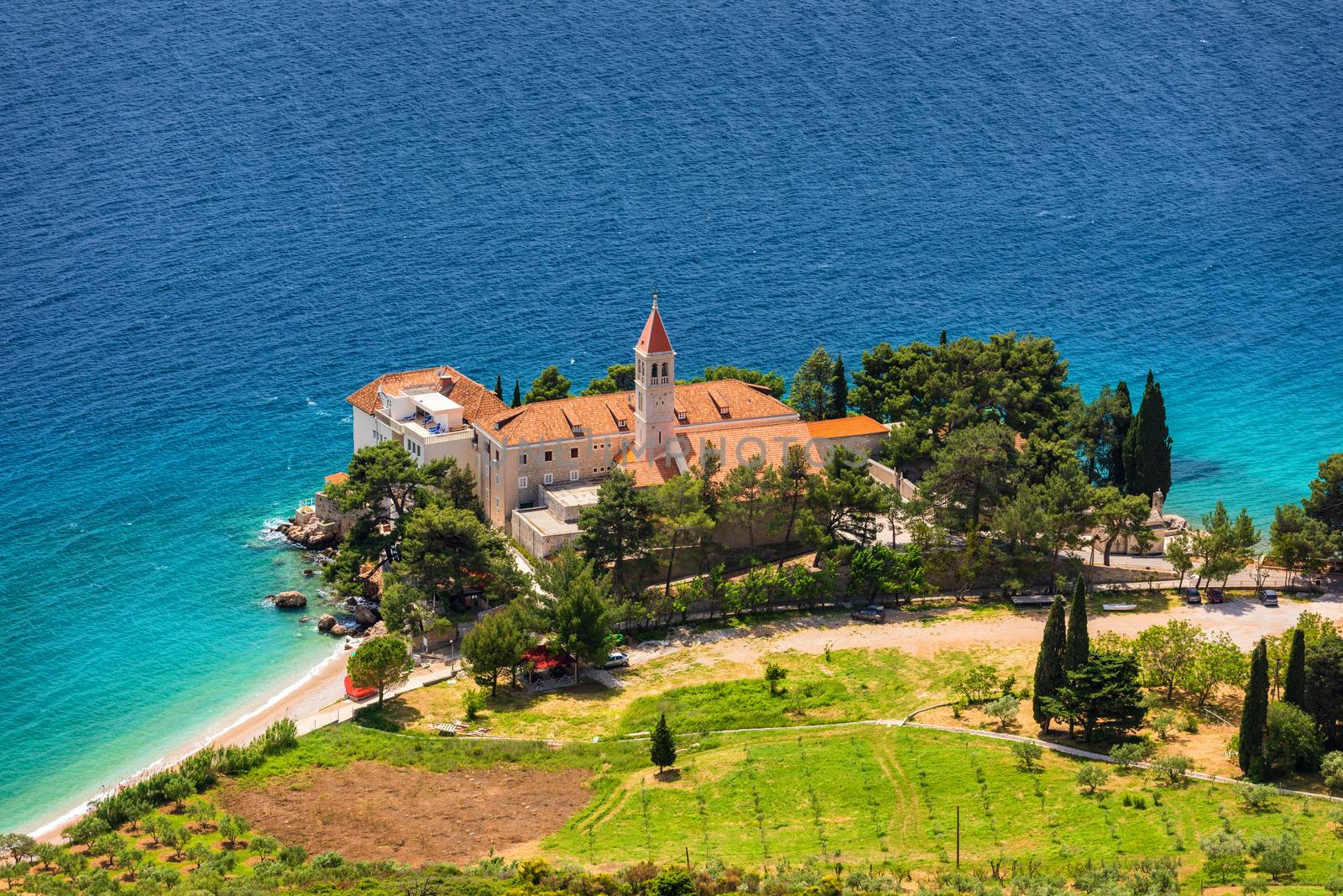 View of beautiful bay with beach and Dominican monastery in Bol town, Brac island, Croatia. Dominican monastery in Bol, built in 15th century. Bol town, Brac island, Croatia.