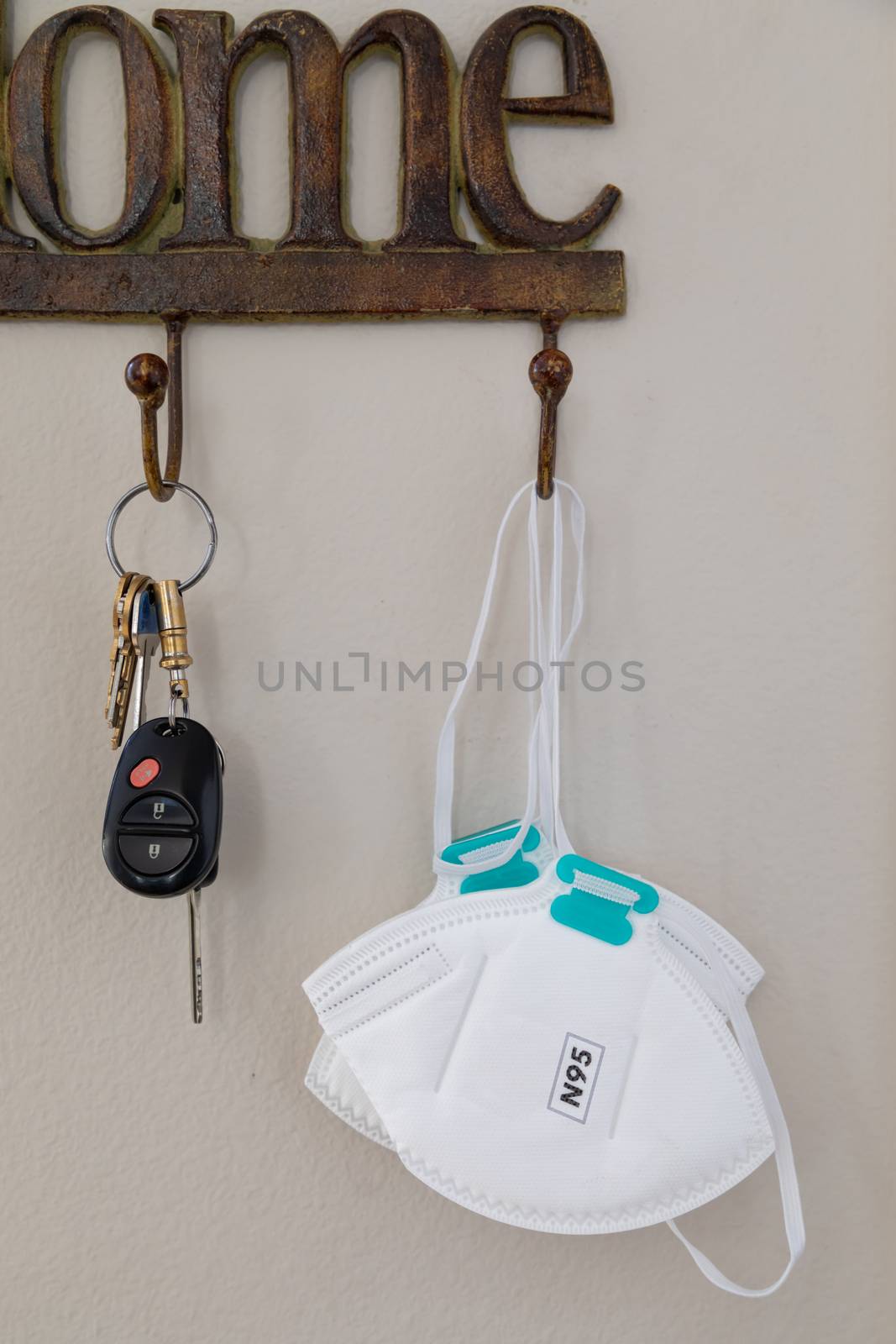 Home Key Hanger Rack Next to Door With Keys and Medical Face Mask During Coronavirus Pandemic. by Feverpitched