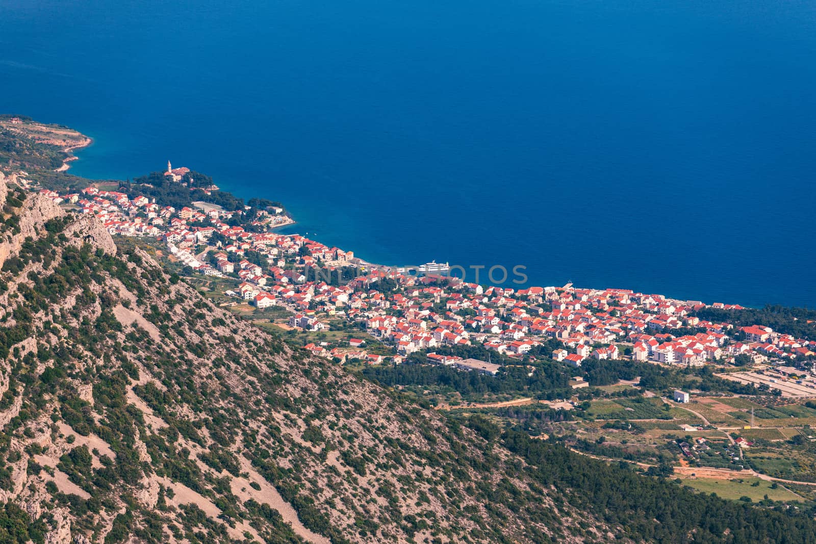 View on mountains and sea from Vidova Gora on Brac island. View from the mountain Vidova Gora on the island Brac in Croatia with the famous landmark Zlatni Rat near the city of Bol an the blue sea.
