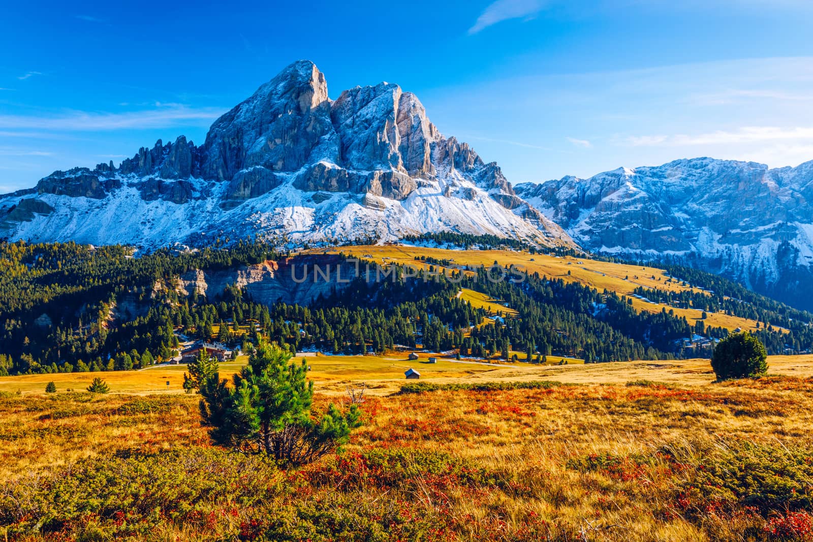 Stunning view of Peitlerkofel mountain from Passo delle Erbe in Dolomites, Italy. View of Sass de Putia (Peitlerkofel) at Passo delle Erbe, with wooden farm houses, Dolomites, South Tyrol, Italy.