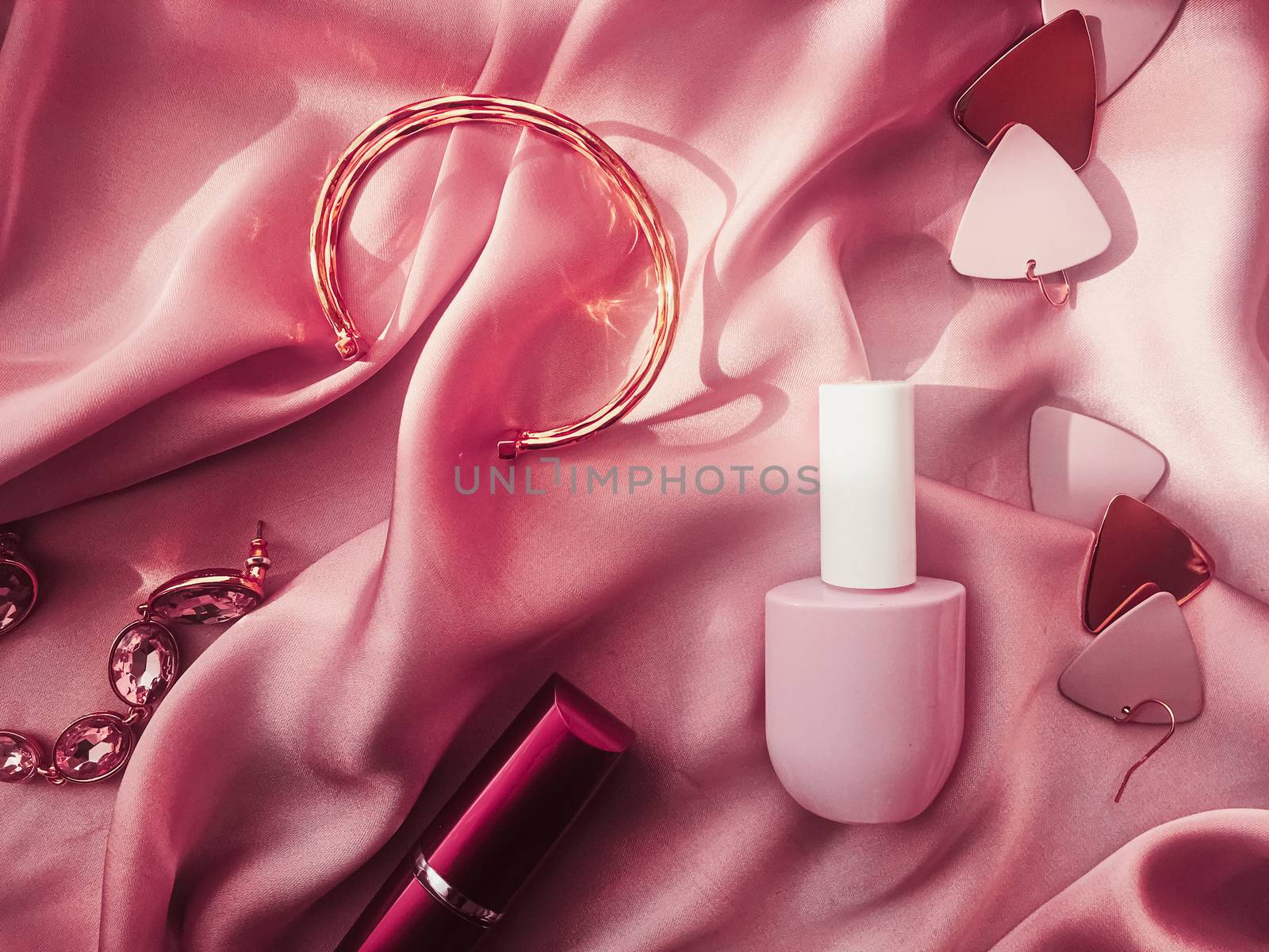 Fashionable and stylish accessories, jewelry and make-up products on pink silk background, beauty and fashion by Anneleven