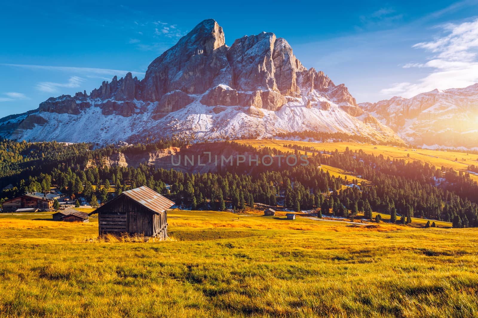 Stunning view of Peitlerkofel mountain from Passo delle Erbe in Dolomites, Italy. View of Sass de Putia (Peitlerkofel) at Passo delle Erbe, with wooden farm houses, Dolomites, South Tyrol, Italy.