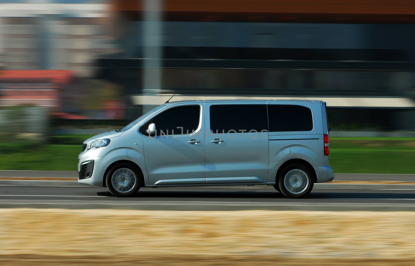 Fast moving gray minibus on the road